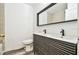 Bathroom featuring double vanity, hardwood floors, and a white toilet at 1247 21St St, Sarasota, FL 34234