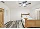 Comfortable bedroom with wood-look flooring, a wooden bed frame and a dresser at 1247 21St St, Sarasota, FL 34234