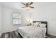 Bright bedroom with light floral bedding, wood-look flooring and plenty of natural light at 1247 21St St, Sarasota, FL 34234