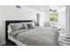 Cozy bedroom with a ceiling fan, chair, and wood-look floors, with lots of natural light at 1247 21St St, Sarasota, FL 34234