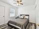 Inviting bedroom with wood-look floors, a ceiling fan, and natural light from the window at 1247 21St St, Sarasota, FL 34234