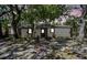 Charming single-story home with mature trees and a welcoming entrance with a gray door at 1247 21St St, Sarasota, FL 34234