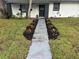 Charming home featuring a front yard with a walkway lined with colorful plants leading to the front door at 1247 21St St, Sarasota, FL 34234
