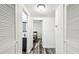 Hallway featuring neutral paint and hardwood floors, and an open door to a bathroom at 1247 21St St, Sarasota, FL 34234