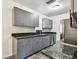Modern kitchen featuring gray cabinets, granite countertops, and stainless steel appliances at 1247 21St St, Sarasota, FL 34234