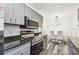 Modern kitchen featuring stainless steel appliances, granite countertops, and sleek grey cabinetry at 1247 21St St, Sarasota, FL 34234