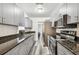 Modern kitchen featuring stainless steel appliances, granite countertops, and sleek grey cabinetry at 1247 21St St, Sarasota, FL 34234
