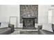 Cozy living room featuring a stone fireplace, plush sofas, and stylish decor at 1247 21St St, Sarasota, FL 34234
