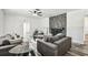 A contemporary living area offers a cozy seating arrangement, complemented by a stone fireplace and modern lighting at 1247 21St St, Sarasota, FL 34234