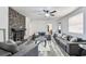 Spacious living room featuring a stone fireplace, ceiling fan, and wood-look flooring at 1247 21St St, Sarasota, FL 34234