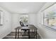 Bright home office featuring a wooden desk, comfortable chair, and natural light from two windows at 1247 21St St, Sarasota, FL 34234