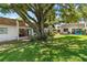 Relaxing backyard featuring a cozy patio, a spacious yard, and mature trees at 1278 Mission Cir # 45B, Clearwater, FL 33759