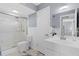 Bright bathroom featuring walk-in shower, white fixtures, and marble floors at 1278 Mission Cir # 45B, Clearwater, FL 33759