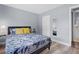 Bedroom with modern bed frame, wood-look flooring, and ensuite bathroom at 1278 Mission Cir # 45B, Clearwater, FL 33759