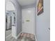 Inviting entryway featuring wood-look floors and a view into the kitchen at 1278 Mission Cir # 45B, Clearwater, FL 33759