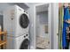Laundry room with stackable washer and dryer, closet, and ensuite bathroom at 1278 Mission Cir # 45B, Clearwater, FL 33759