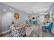 Open-concept living room with stylish furnishings and gray wood floors, with an open view to the bright kitchen at 1278 Mission Cir # 45B, Clearwater, FL 33759