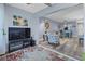 Open-concept living room with gray wood floors, leading to a sunlit kitchen and featuring stylish furnishings at 1278 Mission Cir # 45B, Clearwater, FL 33759