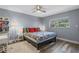 Cozy bedroom with a ceiling fan, decorative pillows, side tables and a large window providing natural light at 1278 Mission Cir # 45B, Clearwater, FL 33759
