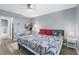 Spacious bedroom with gray wood floors, desk, bedside tables, and a large window providing natural light at 1278 Mission Cir # 45B, Clearwater, FL 33759