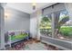 Bright sunroom with a view of the outdoors, featuring a comfortable bench and colorful area rug at 1278 Mission Cir # 45B, Clearwater, FL 33759