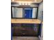 Bathroom vanity featuring double sinks, granite countertop, dark wood cabinets, and large mirror at 1290 Gulf Blvd # 1701, Clearwater Beach, FL 33767