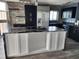 Island in modern kitchen with cooktop and stainless steel appliances, with light, hardwood floors at 1290 Gulf Blvd # 1701, Clearwater Beach, FL 33767