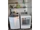 Bright laundry room with modern washer and dryer and ample shelving for storage at 1290 Gulf Blvd # 1701, Clearwater Beach, FL 33767