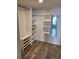 Walk-in closet features custom shelving and wood look floors at 1290 Gulf Blvd # 1701, Clearwater Beach, FL 33767