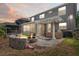 Lovely outdoor space showcasing a fire pit and covered patio with outdoor kitchen and grill area at 12935 Solola Way, Trinity, FL 34655