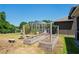 Landscaped backyard featuring raised garden beds and a view of the screened pool enclosure at 12935 Solola Way, Trinity, FL 34655