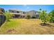 Spacious backyard with a fire pit and screened in porch areas for entertaining and relaxing at 12935 Solola Way, Trinity, FL 34655