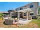 Backyard patio featuring a cozy fire pit, an outdoor kitchen with counter seating and a pergola at 12935 Solola Way, Trinity, FL 34655