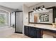 Modern bathroom with a bathtub, walk-in shower, and vanity with marble countertops at 12935 Solola Way, Trinity, FL 34655