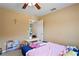 Bright bedroom features neutral walls, ceiling fan and a doorway leading to other rooms at 12935 Solola Way, Trinity, FL 34655