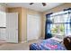 Bright bedroom featuring a window, closet, carpet, and a charming decorative theme at 12935 Solola Way, Trinity, FL 34655