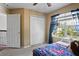 Bright bedroom featuring a window, closet, carpet, and a charming decorative theme at 12935 Solola Way, Trinity, FL 34655