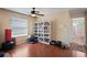 Bonus room featuring hardwood floors, ceiling fan, and a view of an adjoining bathroom at 12935 Solola Way, Trinity, FL 34655