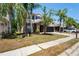 Charming two-story home with a brick facade, manicured lawn, and a three car garage at 12935 Solola Way, Trinity, FL 34655