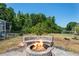 Backyard area featuring a fire pit, bench seating, and landscaping at 12935 Solola Way, Trinity, FL 34655
