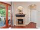 Cozy fireplace with a mantle, view to outdoor patio and access to closet storage at 12935 Solola Way, Trinity, FL 34655