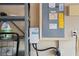 View of garage interior with electrical panel, charging station and metal shelves at 12935 Solola Way, Trinity, FL 34655