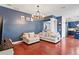 Spacious living room features hardwood floors, a cozy couch set, and a decorative chandelier at 12935 Solola Way, Trinity, FL 34655