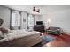 Spacious main bedroom featuring hardwood floors, soft lighting, and seating at 12935 Solola Way, Trinity, FL 34655