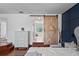 Main bedroom showcasing ensuite bathroom access via modern barn door at 12935 Solola Way, Trinity, FL 34655