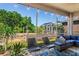 Cozy screened patio featuring a comfortable seating area and views of the landscaped backyard at 12935 Solola Way, Trinity, FL 34655