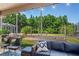 Cozy screened patio featuring a comfortable seating area and views of the landscaped backyard at 12935 Solola Way, Trinity, FL 34655