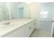 Bright bathroom featuring a double sink vanity, white cabinets, and neutral color scheme at 13261 Tropical Breeze Way, Hudson, FL 34669