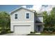 Charming two-story home featuring horizontal siding, a two-car garage, and a welcoming front entrance at 13261 Tropical Breeze Way, Hudson, FL 34669