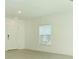 Bright, airy living room with neutral paint, window, and tile flooring at 13261 Tropical Breeze Way, Hudson, FL 34669